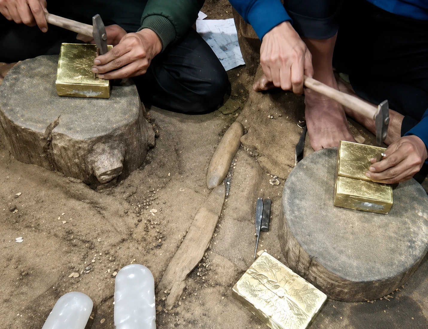 Craftsmen working on stone anvils