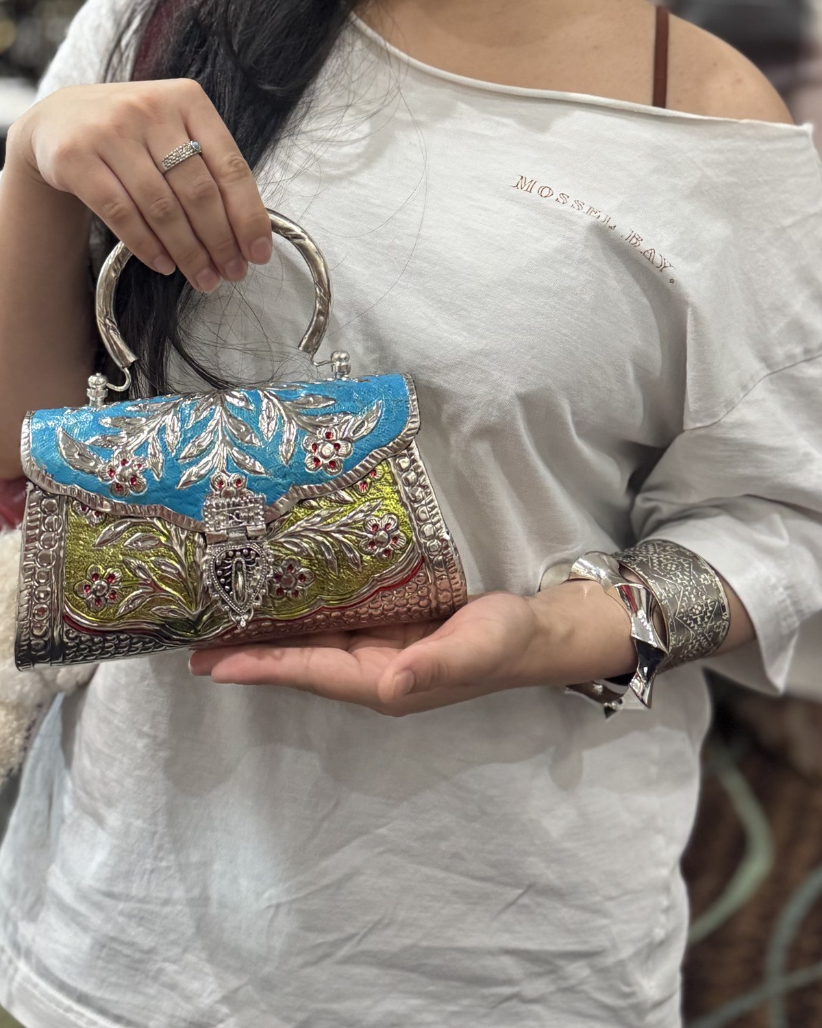 A customer holding the colorful handcrafted Vallari bag at the VARNA pop-up